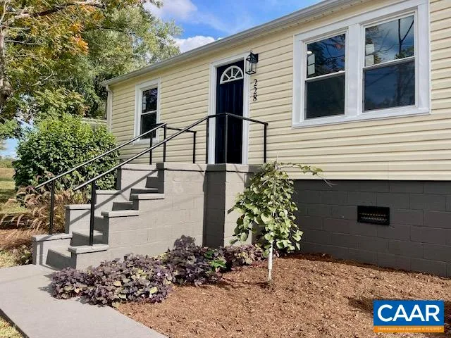 a view of a house with potted plants