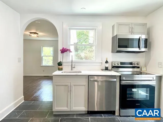 a kitchen with a sink stove and microwave