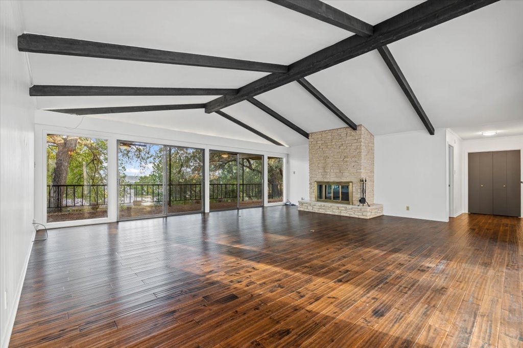 313 Comet Lakeway, TX 78734 - Photo 1 of 17 Living room featuring a brick fireplace and real wood finished floors