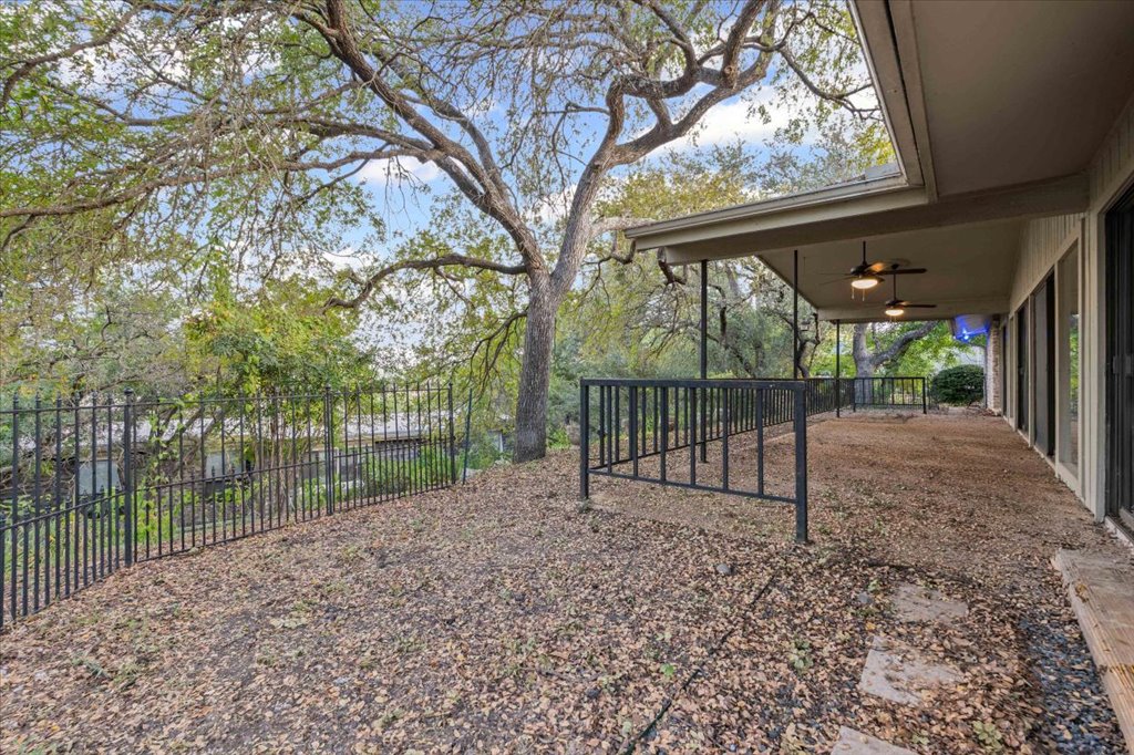 313 Comet Lakeway, TX 78734 - Photo 12 of 17 Fenced backyard with ceiling fan and a patio area