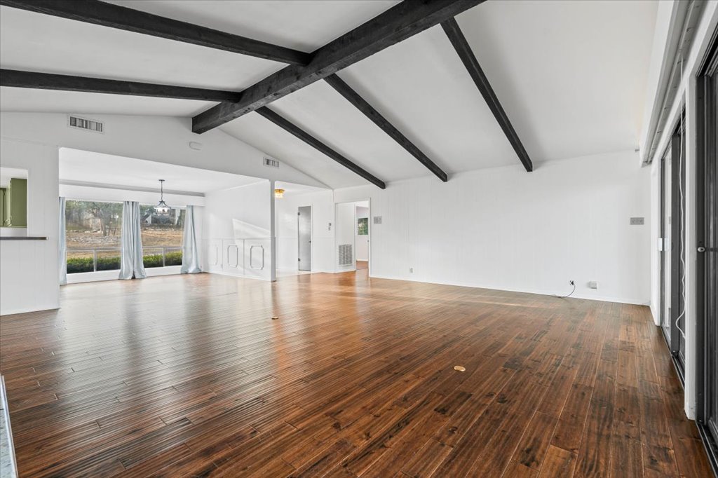 313 Comet Lakeway, TX 78734 - Photo 3 of 17 Living room featuring real wood finished floors, dining room and a chandelier