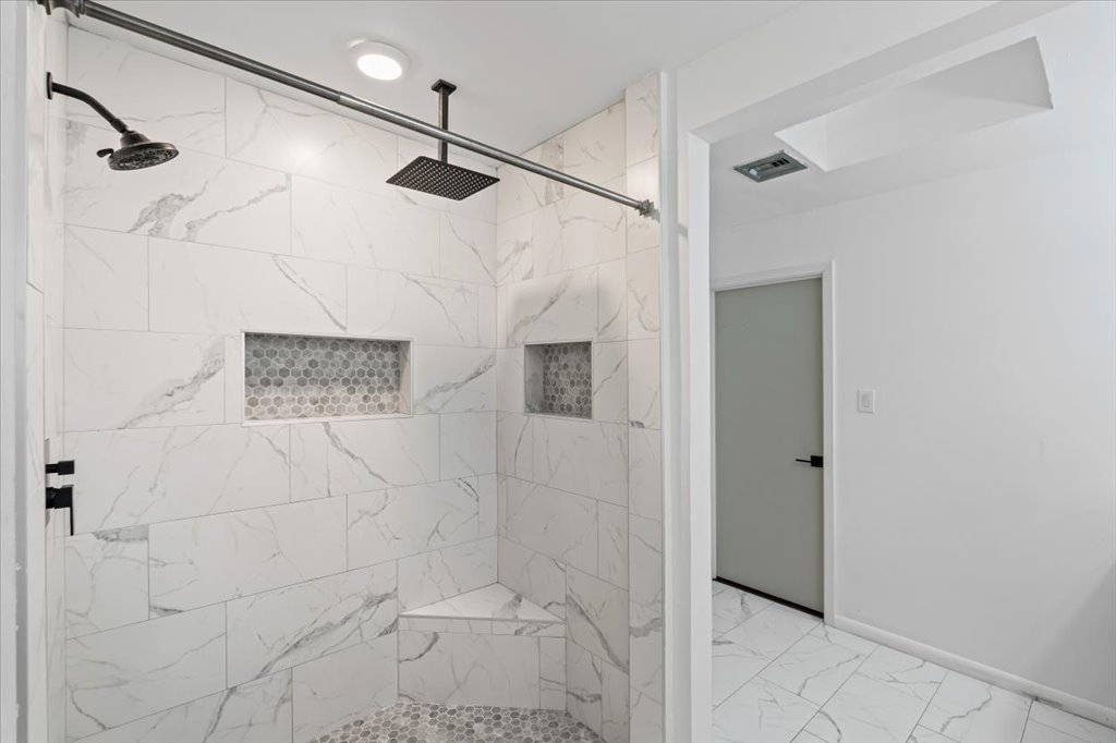 313 Comet Lakeway, TX 78734 - Photo 7 of 17 Primary Bathroom with light marble finish flooring and a marble finish shower