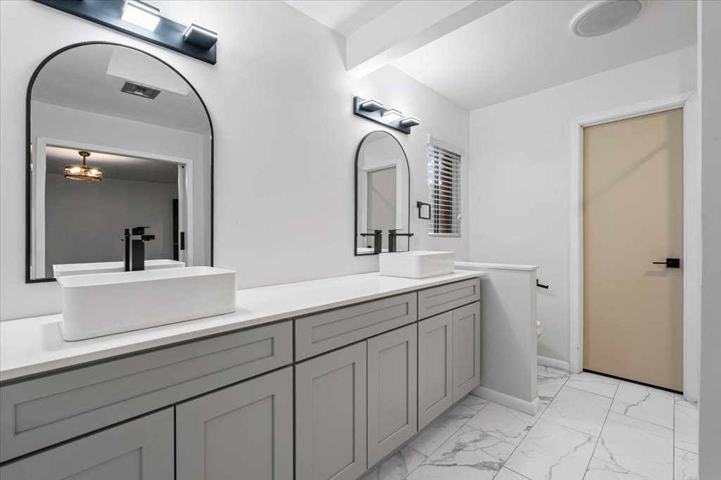 313 Comet Lakeway, TX 78734 - Photo 8 of 17 Primary Bathroom featuring light marble finish flooring, and double vanity