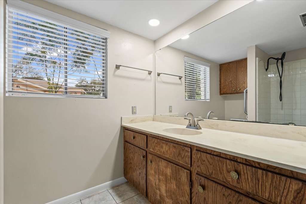 313 Comet Lakeway, TX 78734 - Photo 10 of 17 Full bath featuring vanity, light tile floors, tiled shower, and recessed lighting