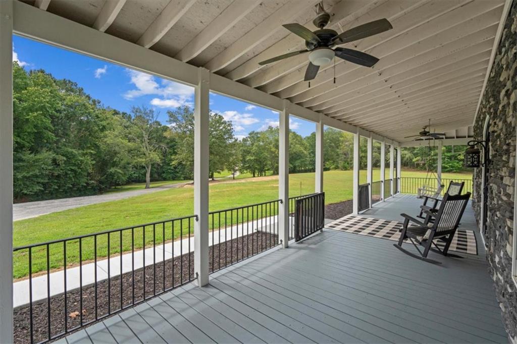 3002 Highway 101 Rockmart, GA 30153 - Photo 13 of 78 a view of a patio with table and chairs potted plants with wooden floor and fence