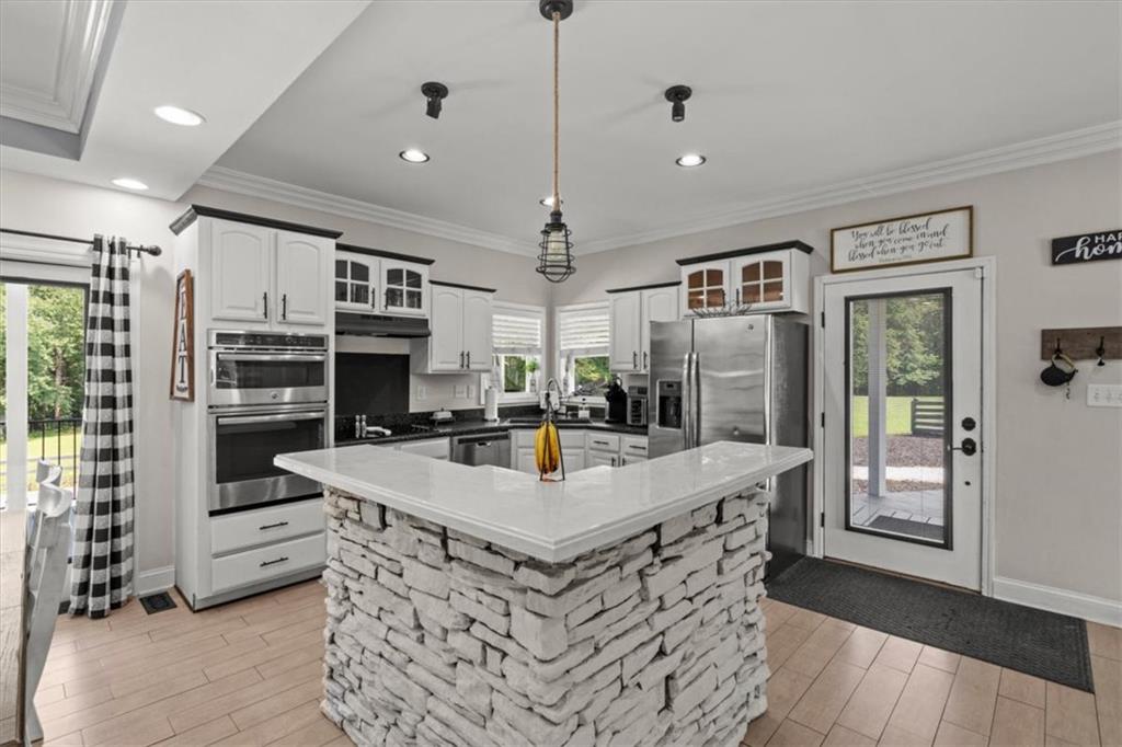 3002 Highway 101 Rockmart, GA 30153 - Photo 17 of 78 a very nice looking kitchen with granite countertop a stove oven and a refrigerator