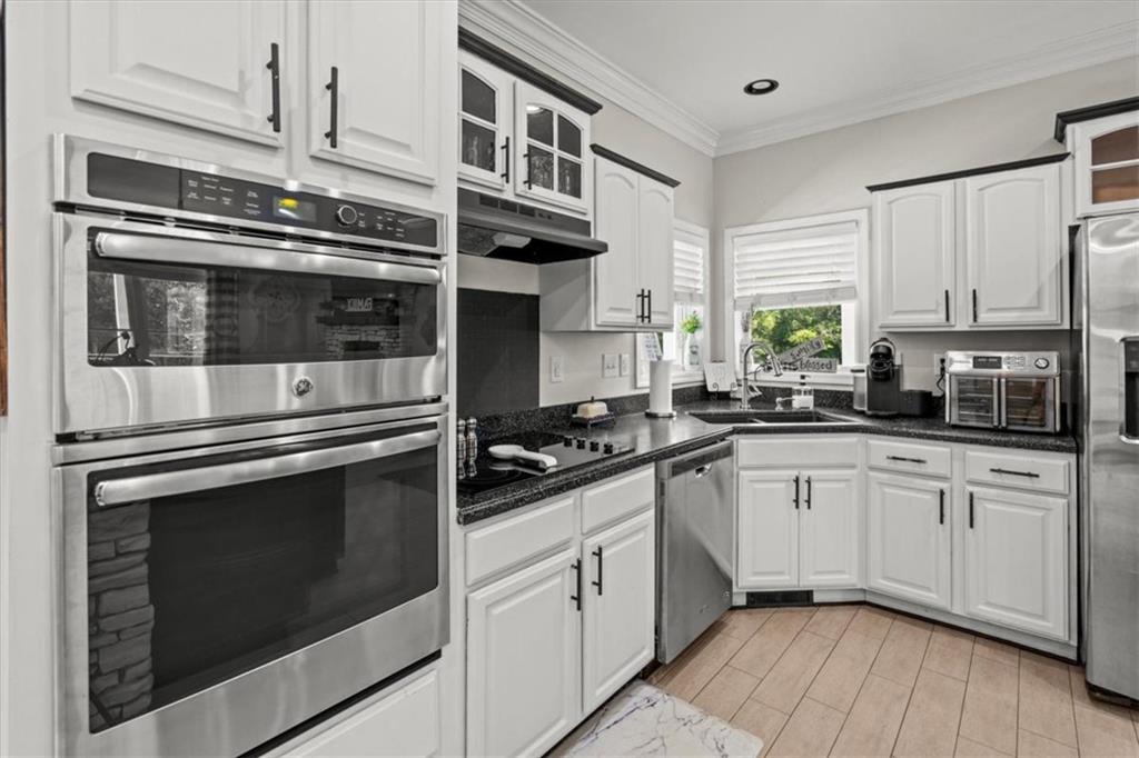 3002 Highway 101 Rockmart, GA 30153 - Photo 22 of 78 a kitchen with stainless steel appliances white cabinets and a stove top oven