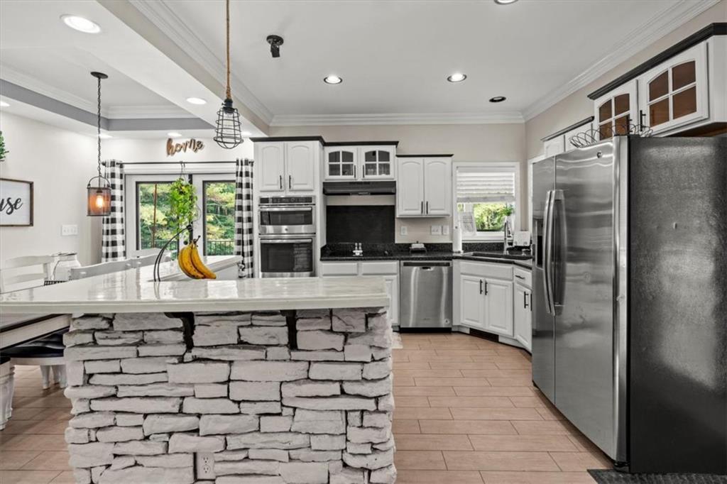 3002 Highway 101 Rockmart, GA 30153 - Photo 23 of 78 a kitchen with stainless steel appliances a refrigerator a sink a stove and cabinets