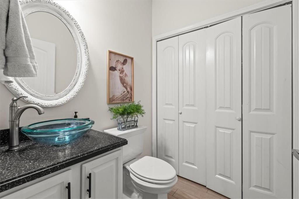 3002 Highway 101 Rockmart, GA 30153 - Photo 25 of 78 a bathroom with a granite countertop sink a toilet and a mirror