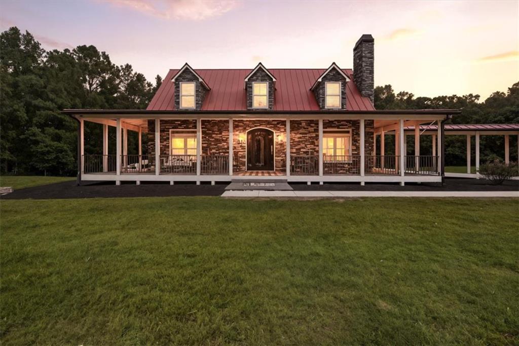 3002 Highway 101 Rockmart, GA 30153 - Photo 3 of 78 a front view of a house with a yard table and chairs