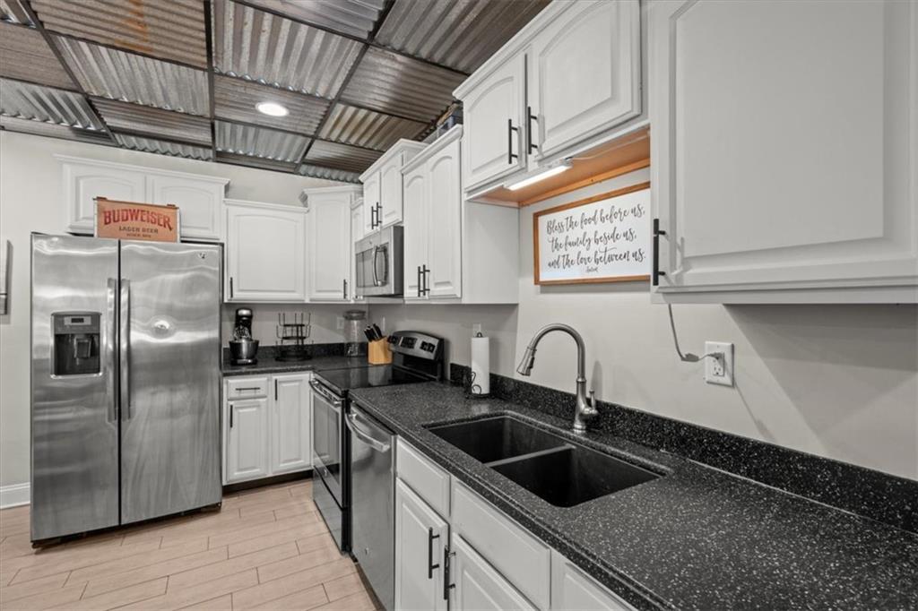 3002 Highway 101 Rockmart, GA 30153 - Photo 47 of 78 a kitchen with granite countertop a sink and refrigerator
