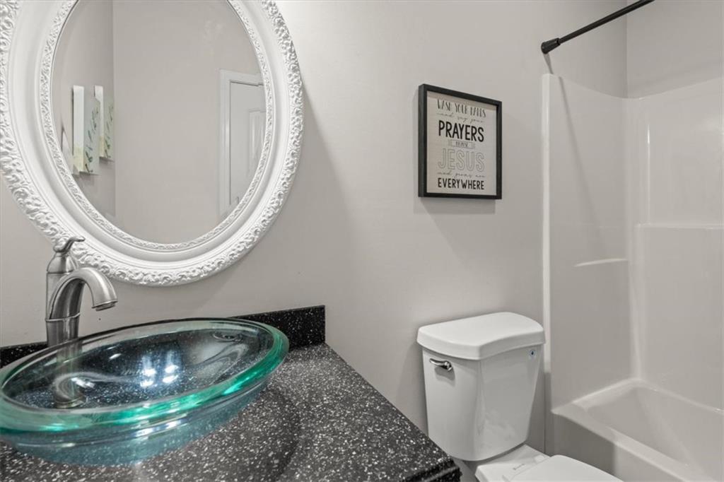 3002 Highway 101 Rockmart, GA 30153 - Photo 52 of 78 a room with a toilet a mirror and tub