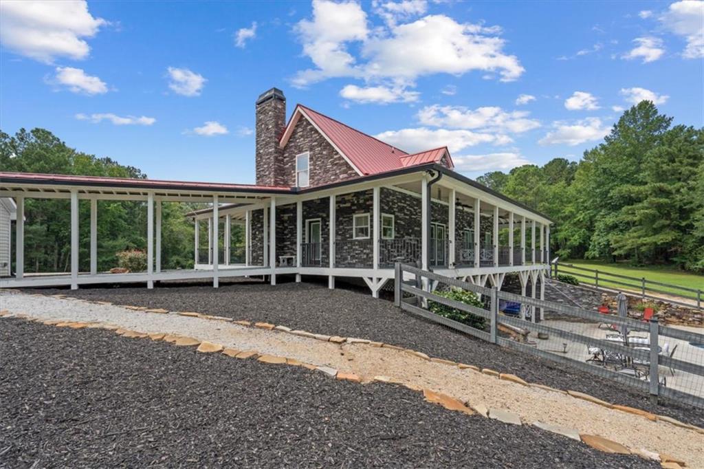 3002 Highway 101 Rockmart, GA 30153 - Photo 66 of 78 a front view of a house with a yard and outdoor seating