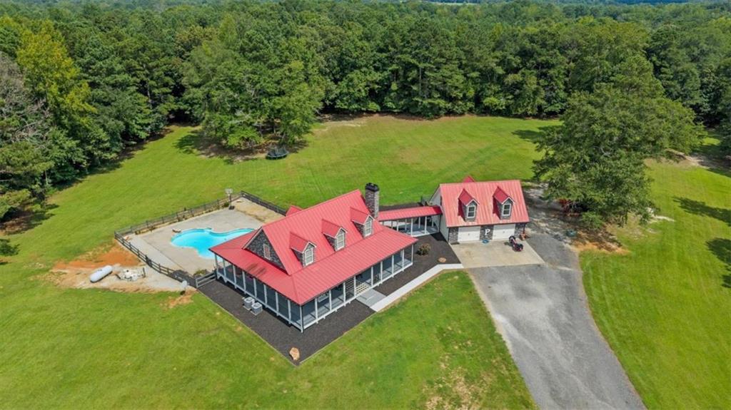 3002 Highway 101 Rockmart, GA 30153 - Photo 9 of 78 an aerial view of a house with pool a yard and lake view