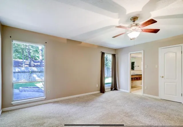 an empty room with windows and closet