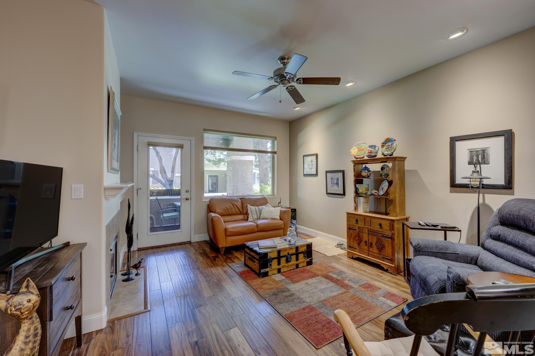 900 S Meadows, Unit 613 Reno, NV 89521 - Photo 14 of 40 a living room with furniture a flat screen tv and a fireplace