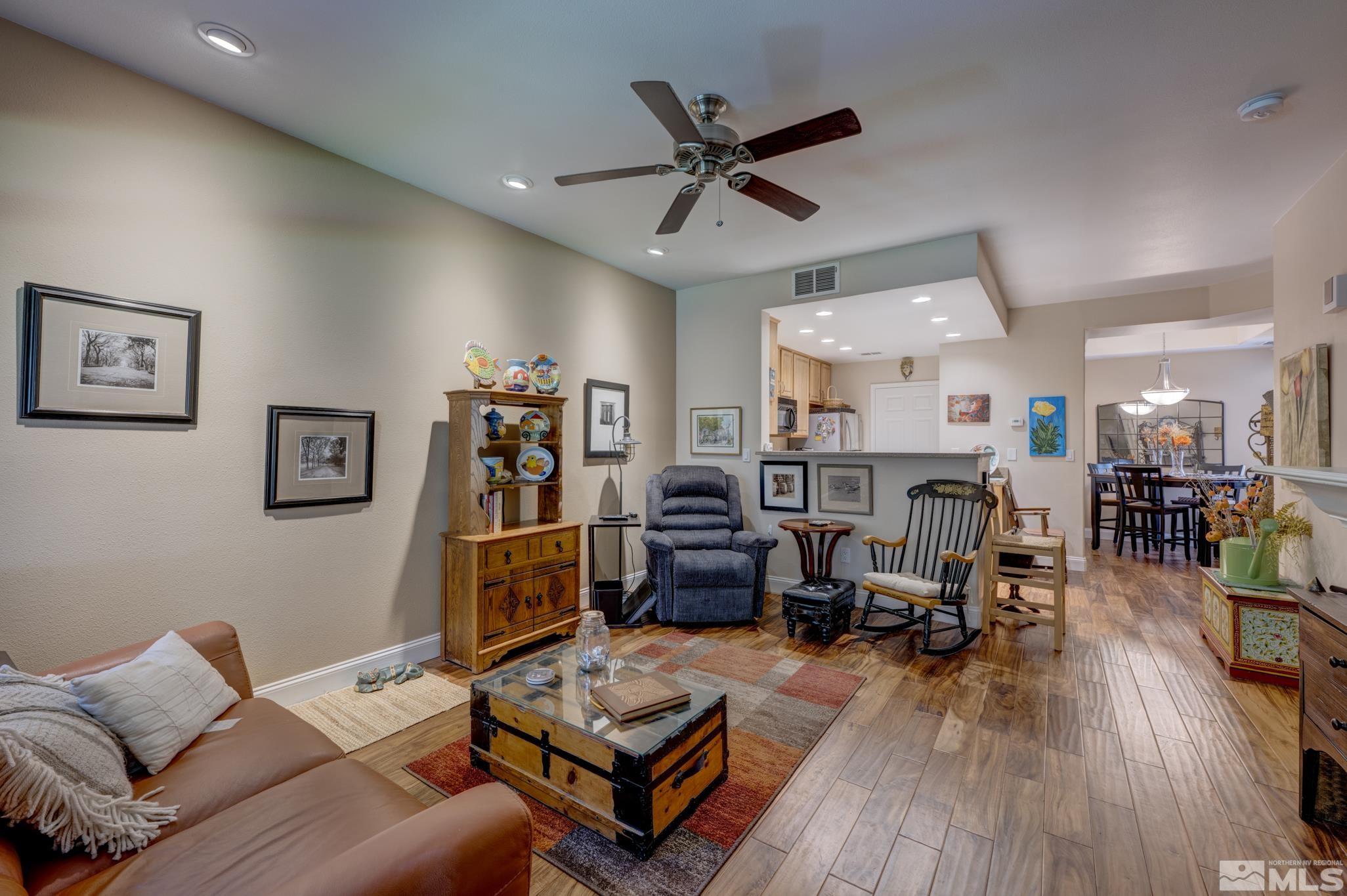 900 S Meadows, Unit 613 Reno, NV 89521 - Photo 15 of 40 a living room with furniture kitchen view and a wooden floor