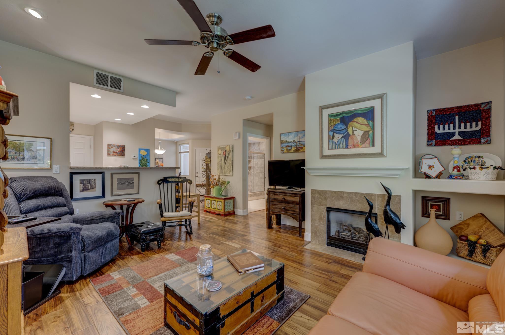 900 S Meadows, Unit 613 Reno, NV 89521 - Photo 16 of 40 a living room with furniture a fireplace