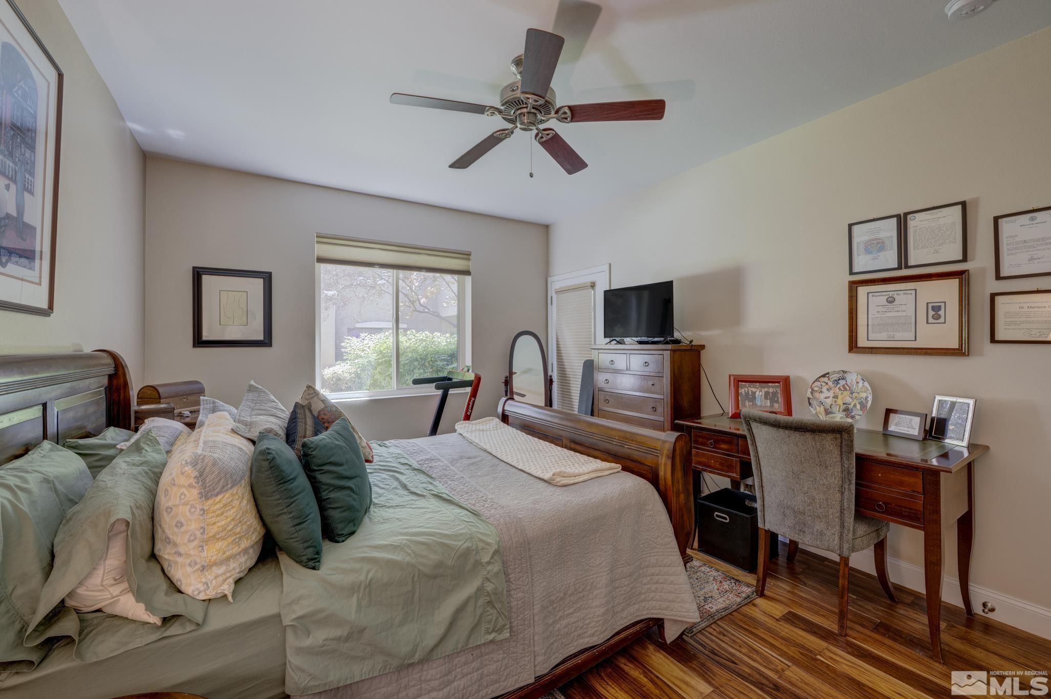 900 S Meadows, Unit 613 Reno, NV 89521 - Photo 6 of 40 a bed room with a bed window and a chair