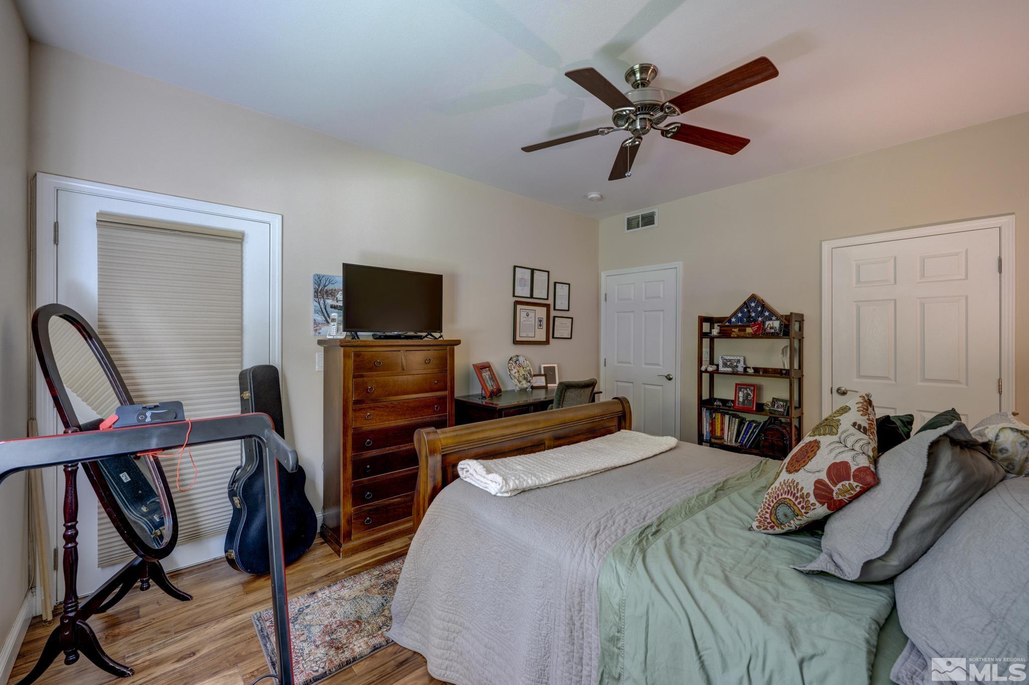 900 S Meadows, Unit 613 Reno, NV 89521 - Photo 7 of 40 a bedroom with a bed and a flat screen tv