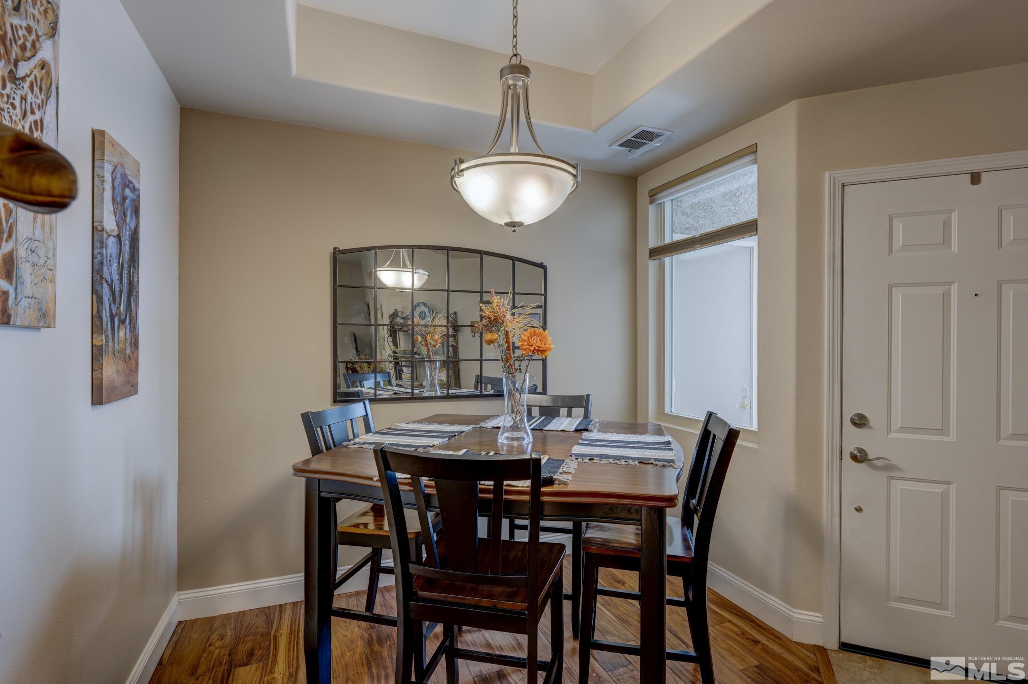 900 S Meadows, Unit 613 Reno, NV 89521 - Photo 8 of 40 a view of a dining room with furniture and wooden floor