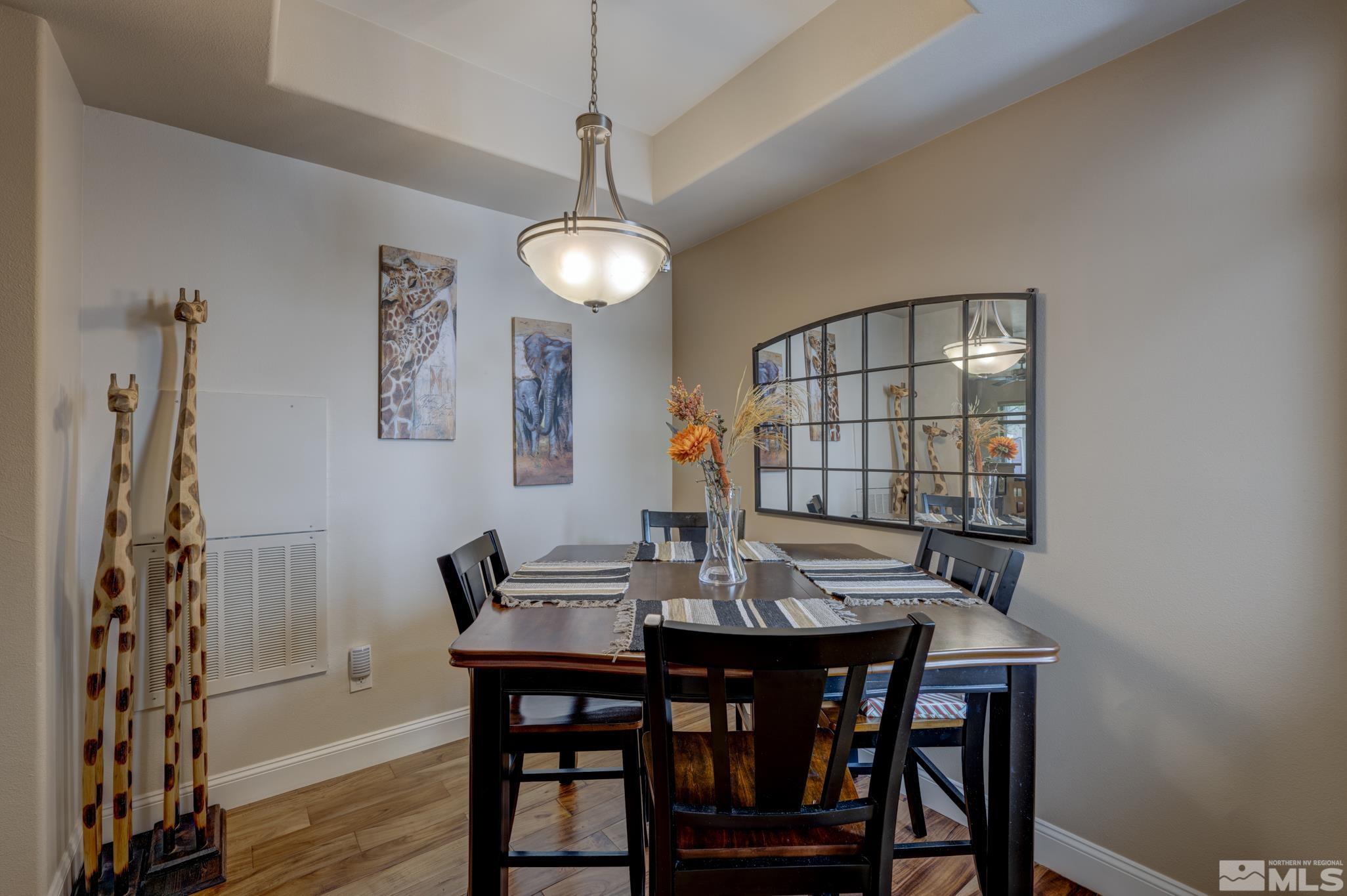 900 S Meadows, Unit 613 Reno, NV 89521 - Photo 9 of 40 a view of a dining room with furniture wooden floor and chandelier