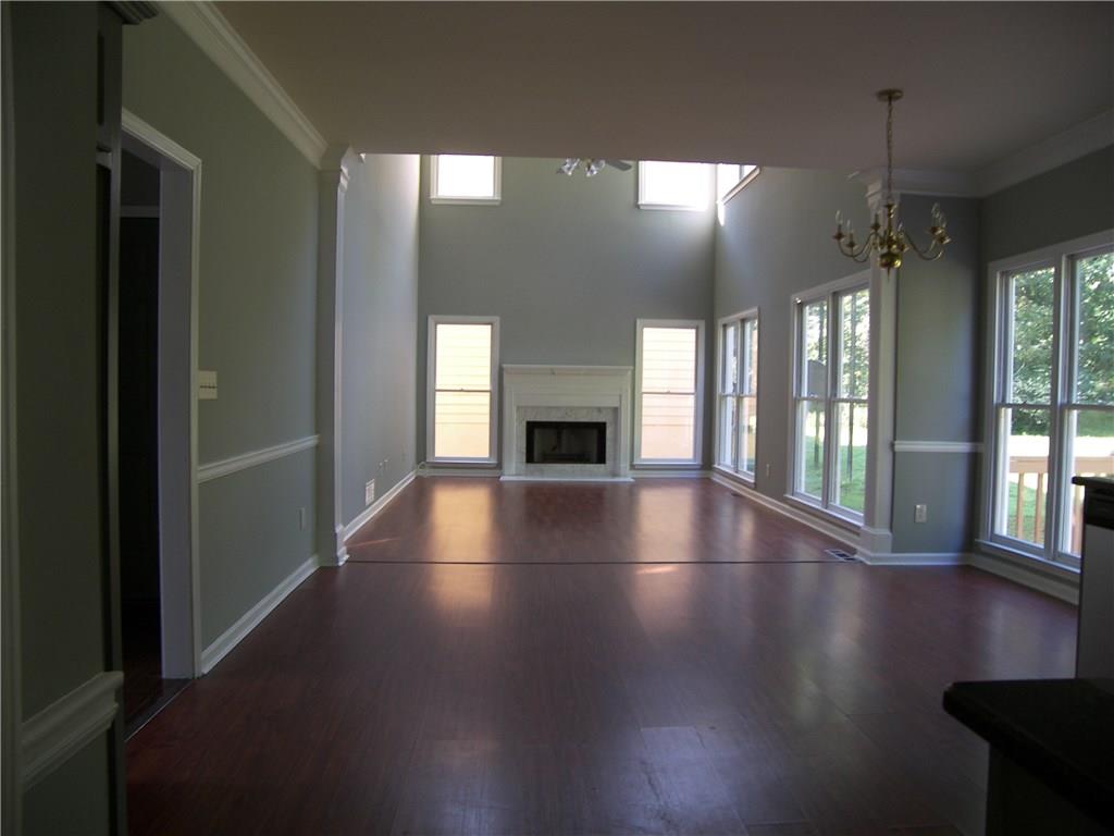514 Rams Court Tucker, GA 30084 - Photo 2 of 14 an empty room with floor to ceiling windows and fireplace