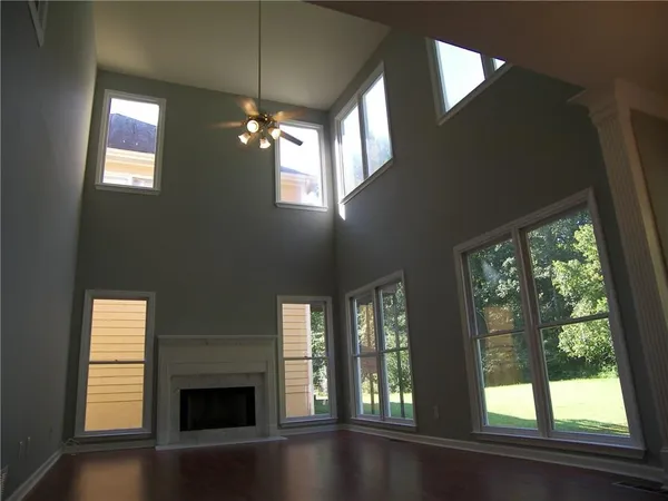 a view of empty room with fireplace and windows
