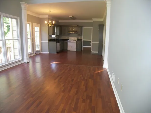 wooden floor in a hall with a window and wooden floor