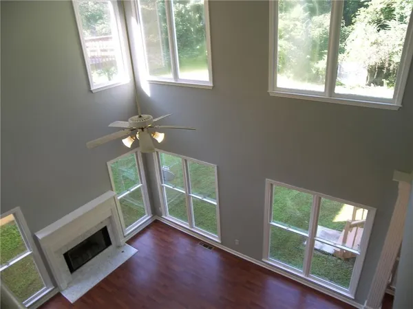 a living room with a fireplace and a large window