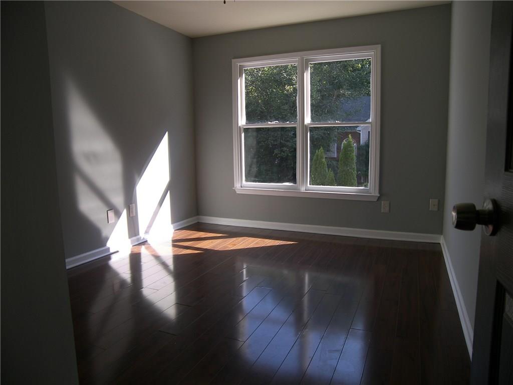 514 Rams Court Tucker, GA 30084 - Photo 7 of 14 a view of empty room with wooden floor and fan