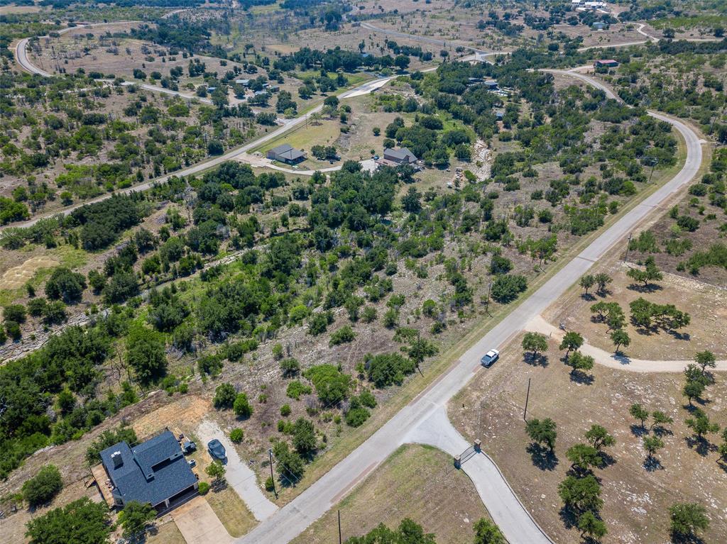 8021 Hells Gate Loop Strawn, TX 76475 - Photo 13 of 39 an aerial view of a house with a yard and lake view