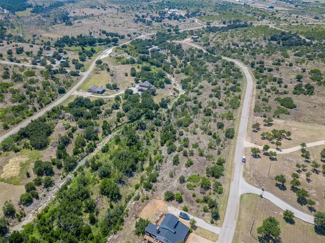 an aerial view of a residential houses with outdoor space