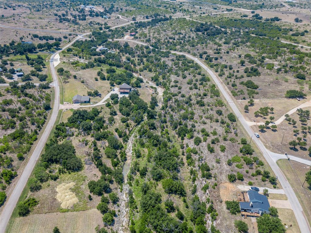 8021 Hells Gate Loop Strawn, TX 76475 - Photo 15 of 39 an aerial view of residential houses with outdoor space