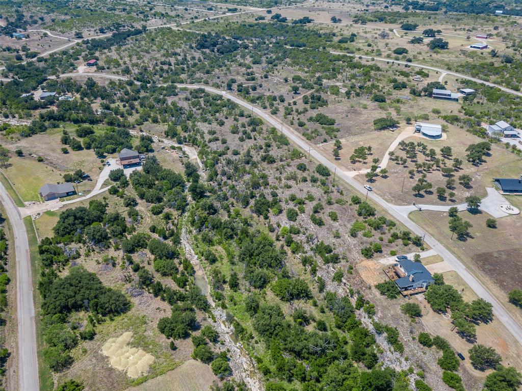 8021 Hells Gate Loop Strawn, TX 76475 - Photo 16 of 39 an aerial view of a house with a yard