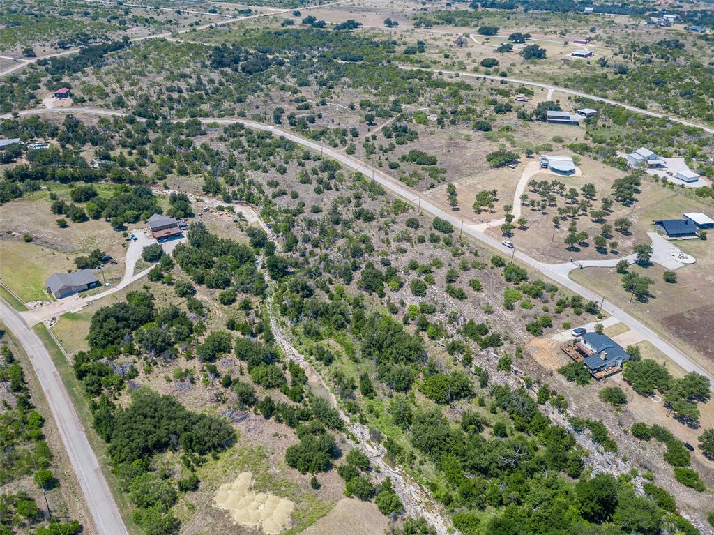 8021 Hells Gate Loop Strawn, TX 76475 - Photo 17 of 39 an aerial view of a house with a yard