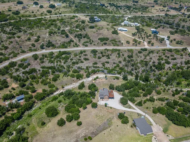 an aerial view of a house with a yard