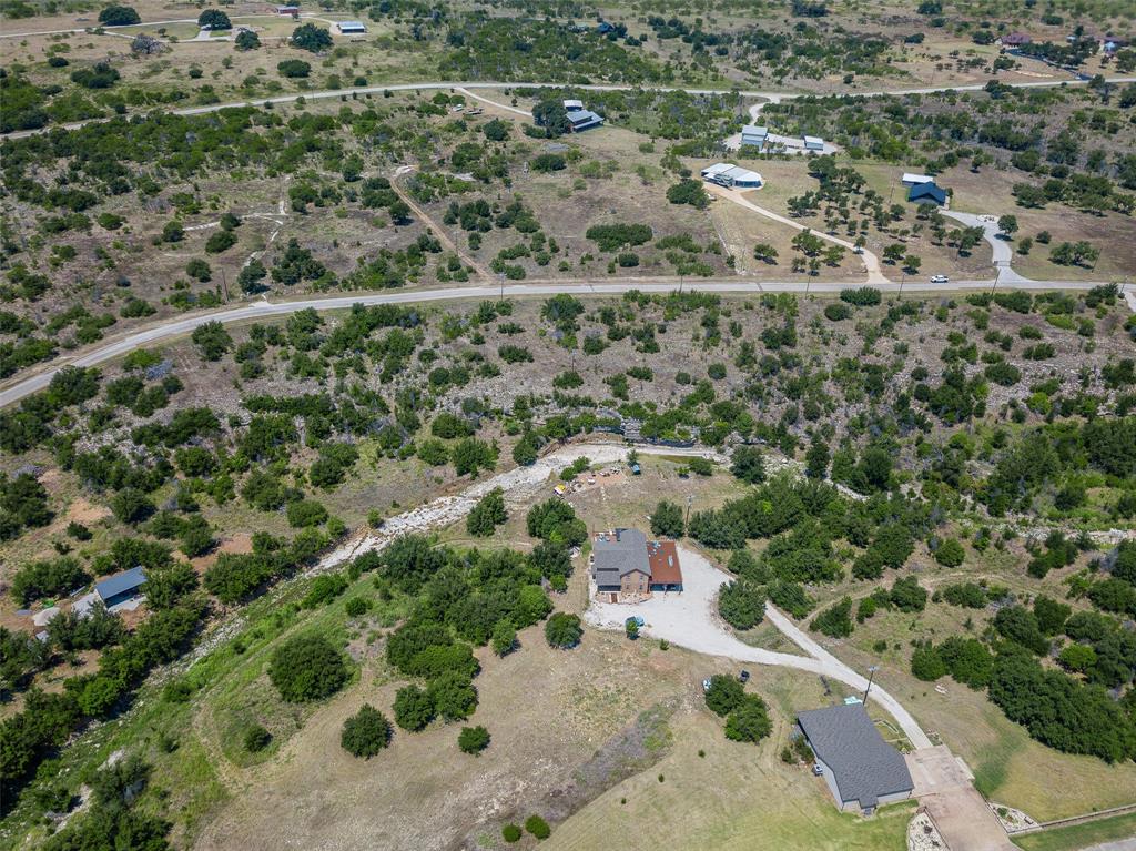 8021 Hells Gate Loop Strawn, TX 76475 - Photo 23 of 39 an aerial view of a house with a yard