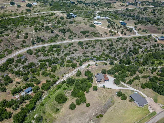 an aerial view of a houses with a yard