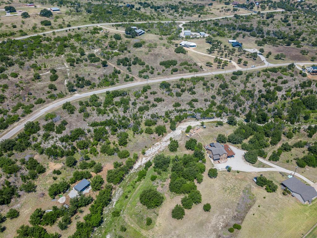 8021 Hells Gate Loop Strawn, TX 76475 - Photo 25 of 39 an aerial view of a houses with a yard