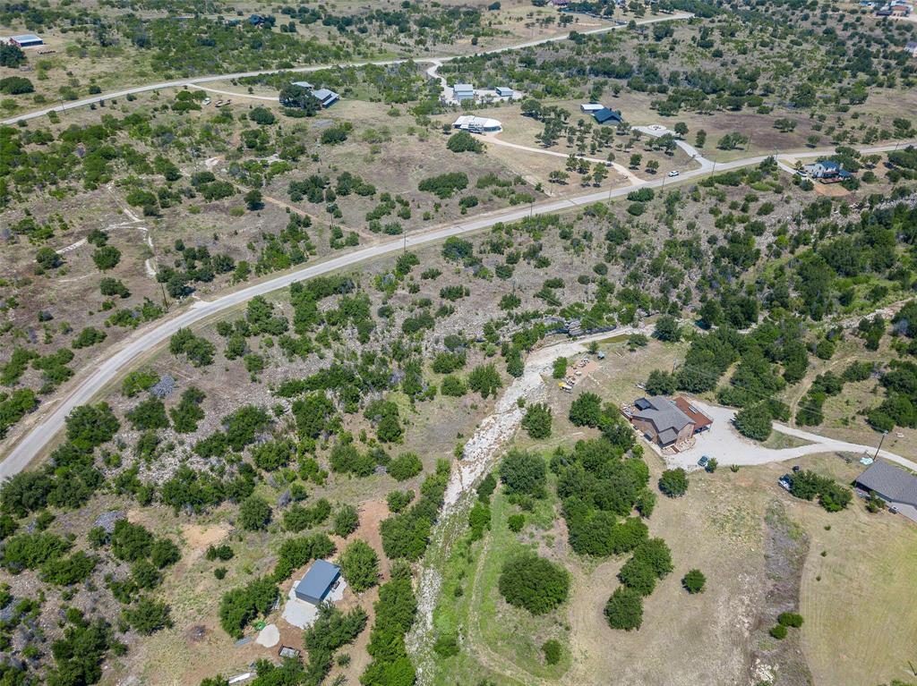 8021 Hells Gate Loop Strawn, TX 76475 - Photo 26 of 39 an aerial view of residential houses with outdoor space