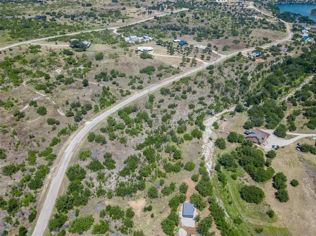 an aerial view of a house with a yard