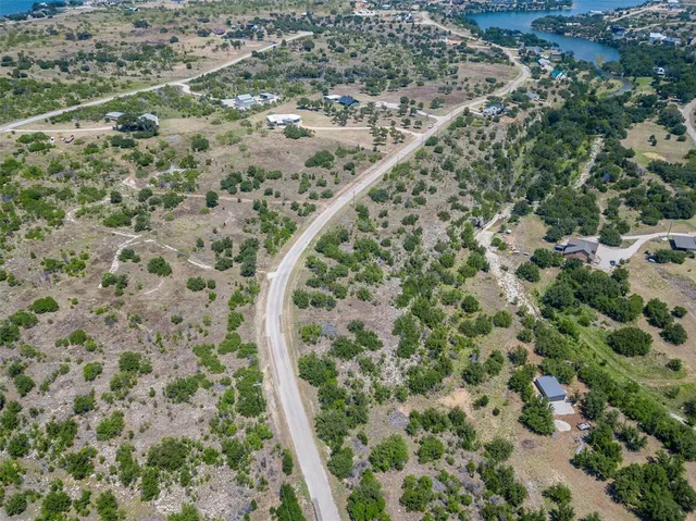 an aerial view of a residential houses with outdoor space