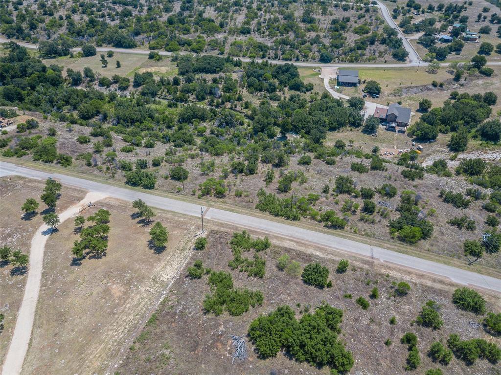 8021 Hells Gate Loop Strawn, TX 76475 - Photo 38 of 39 an aerial view of a house with a yard