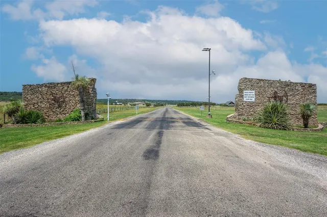 a view of a street with a big yard