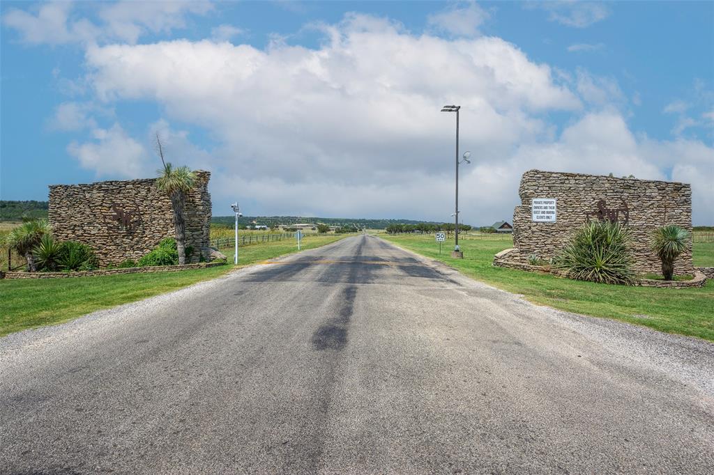 8021 Hells Gate Loop Strawn, TX 76475 - Photo 4 of 39 a view of a street with a big yard