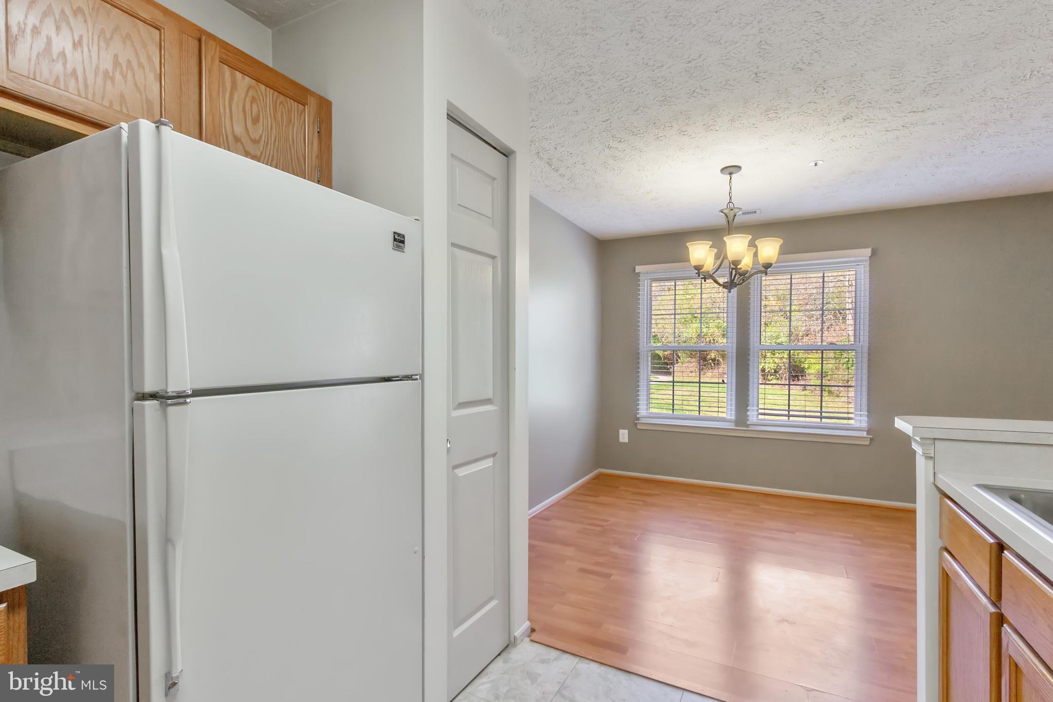 96 Jumpers Circle, Unit 216 Baltimore, MD 21236 - Photo 9 of 29 a view of a kitchen with a refrigerator and a window