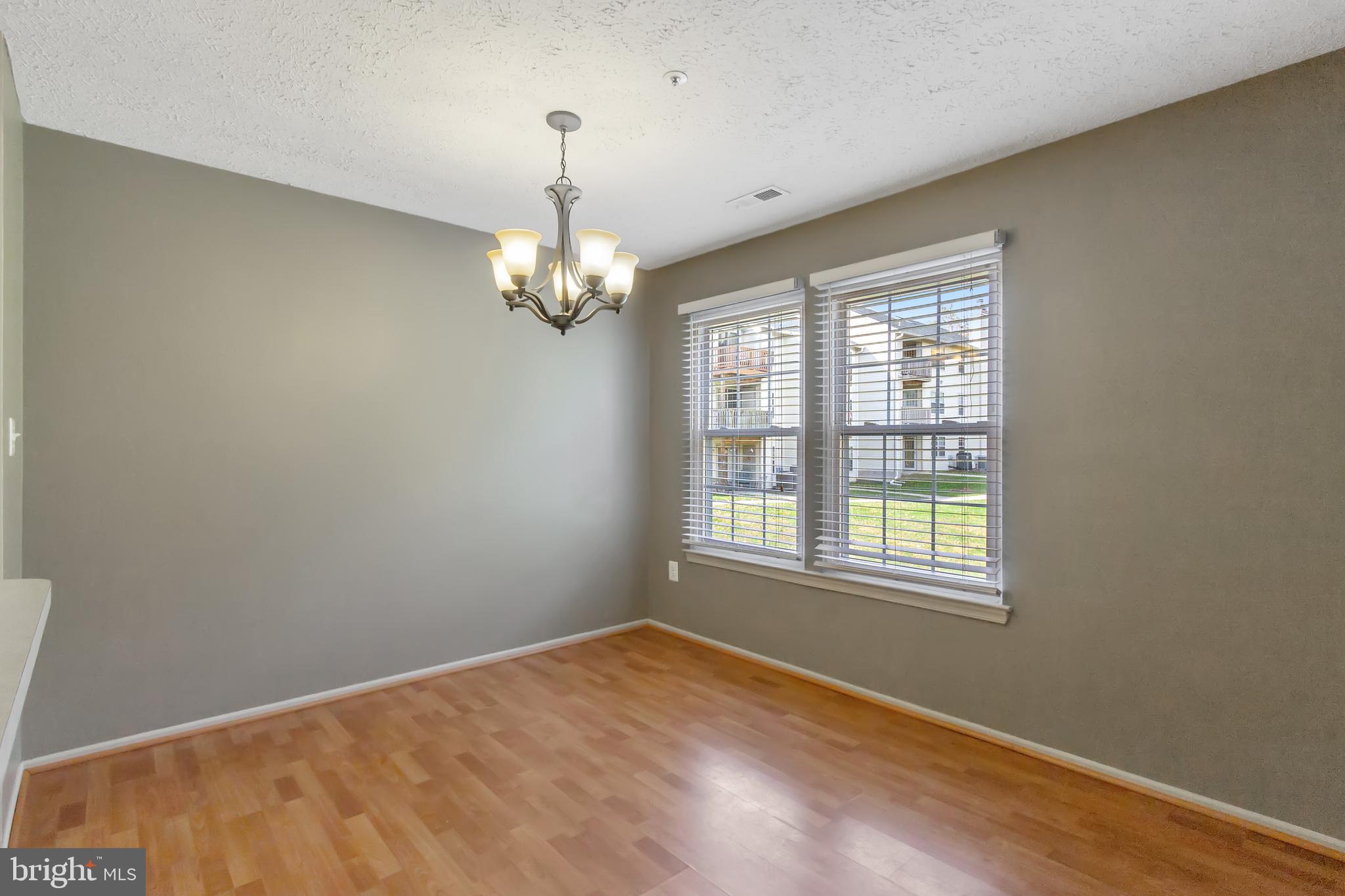 96 Jumpers Circle, Unit 216 Baltimore, MD 21236 - Photo 3 of 29 a view of empty room with wooden floor and fan