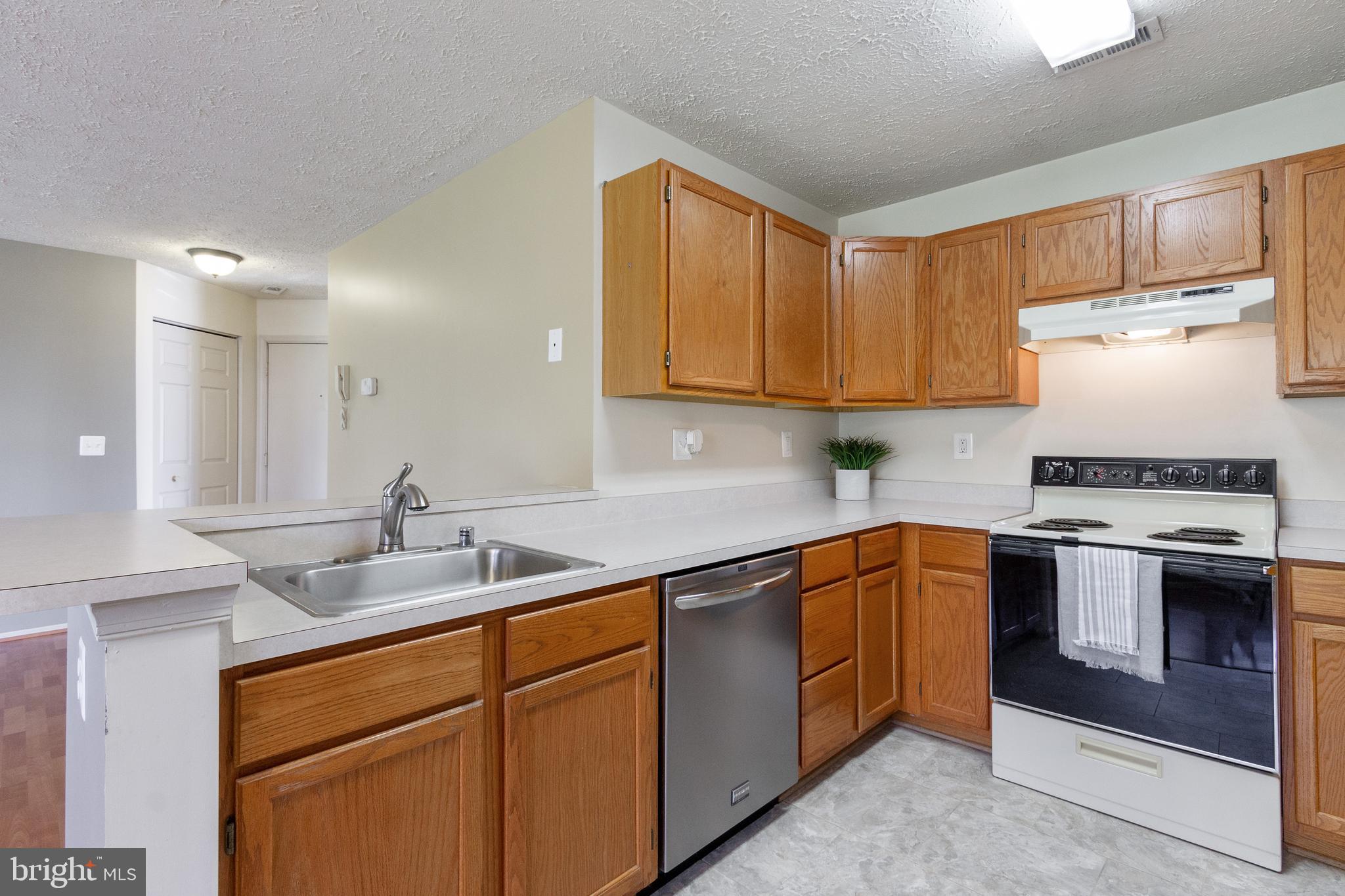 96 Jumpers Circle, Unit 216 Baltimore, MD 21236 - Photo 8 of 29 a kitchen with stainless steel appliances granite countertop a sink stove and cabinets