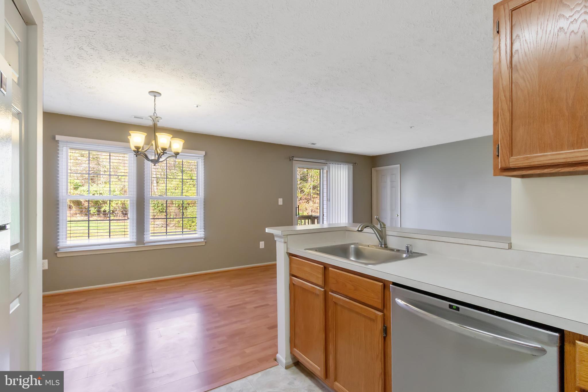 96 Jumpers Circle, Unit 216 Baltimore, MD 21236 - Photo 29 of 29 a kitchen with stainless steel appliances granite countertop a sink a stove and a wooden floors